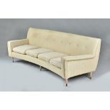 In the manner of Gio Ponti; a mid-20th century cream upholstered curved sofa,