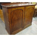 A 19th century mahogany linen cupboard with arch panelled doors on plinth base,