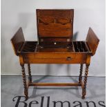 Britisher; a mid-20th century oak folding writing desk on barleytwist supports,