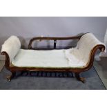 A 19th century French faux rosewood chaise longue with double scroll ends on swept sabre supports,