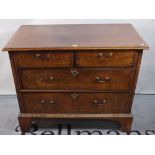 A late 18th century mahogany and walnut chest of two short and two long drawers on bracket feet,