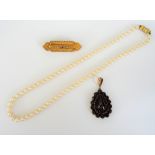 A Bohemian garnet and carbuncle garnet drop shaped pendant,
