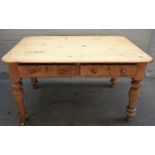 A Victorian pine kitchen table with a pair of frieze drawers on turned supports,