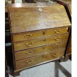 A George III mahogany bureau, the fall over four long drawers on bracket feet,
