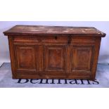 A 17th century French elm coffer, the plank top over carved triple panel front, dated 1690,