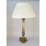 An Ormolu table lamp of fluted column form raised on three lion paw feet and a triform shaped base
