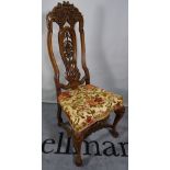 A Queen Anne style walnut highback dining chair with carved back on ball and claw feet.