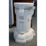 A pair of white marble pedestal columns, each with foliate carved and fluted decoration,