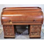 A Victorian mahogany roll top desk with fitted interior over six pedestal drawers,