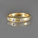 A gold and platinum, diamond set eternity ring, mounted with circular cut diamonds,