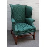 A mid-18th century mahogany framed wingback armchair on square supports, 81cm wide x 114cm high.