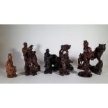A group of eight 20th century Chinese hardwood figures, including; a tiger,