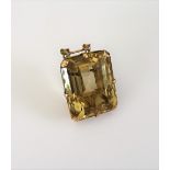 A gold and citrine single stone pendant, claw set with a large rectangular step cut citrine,