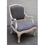 A Louis XV style grey painted open armchair on scroll supports, 70cm wide x 100cm high.