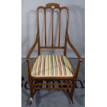 An Edwardian mahogany and inlaid rocking chair.