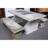 A faux stone rectangular garden table on a pair of acanthus scrolling trestle supports,