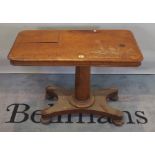 A Regency mahogany reading table on quatrefoil base and bun feet, 91cm wide x 70cm high.