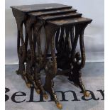 A Victorian nest of four parcel gilt papier-mâché occasional tables on pierced trestle supports,