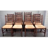 A set of eight 18th century style rush seated ladder back dining chairs,