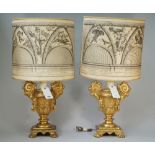 A pair of modern giltwood table lamps each of two handled urn form raised on four lion paw feet