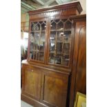 A mahogany library bookcase, Regency top on associated base,