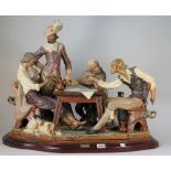 A Lladro matt glaze figure group 'Men Playing Cards' Huenta & Ruiz to the base on a shaped wooden