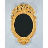 A 19th century Italian gilt framed oval wall mirror with cartouche upper and lower frieze,