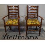 A pair of 18th century style oak ladder back open armchairs, (2).