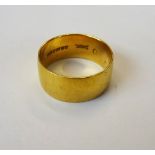 A 22ct gold wide band wedding ring, Birmingham 1970, ring size R, weight 7.7 gms.