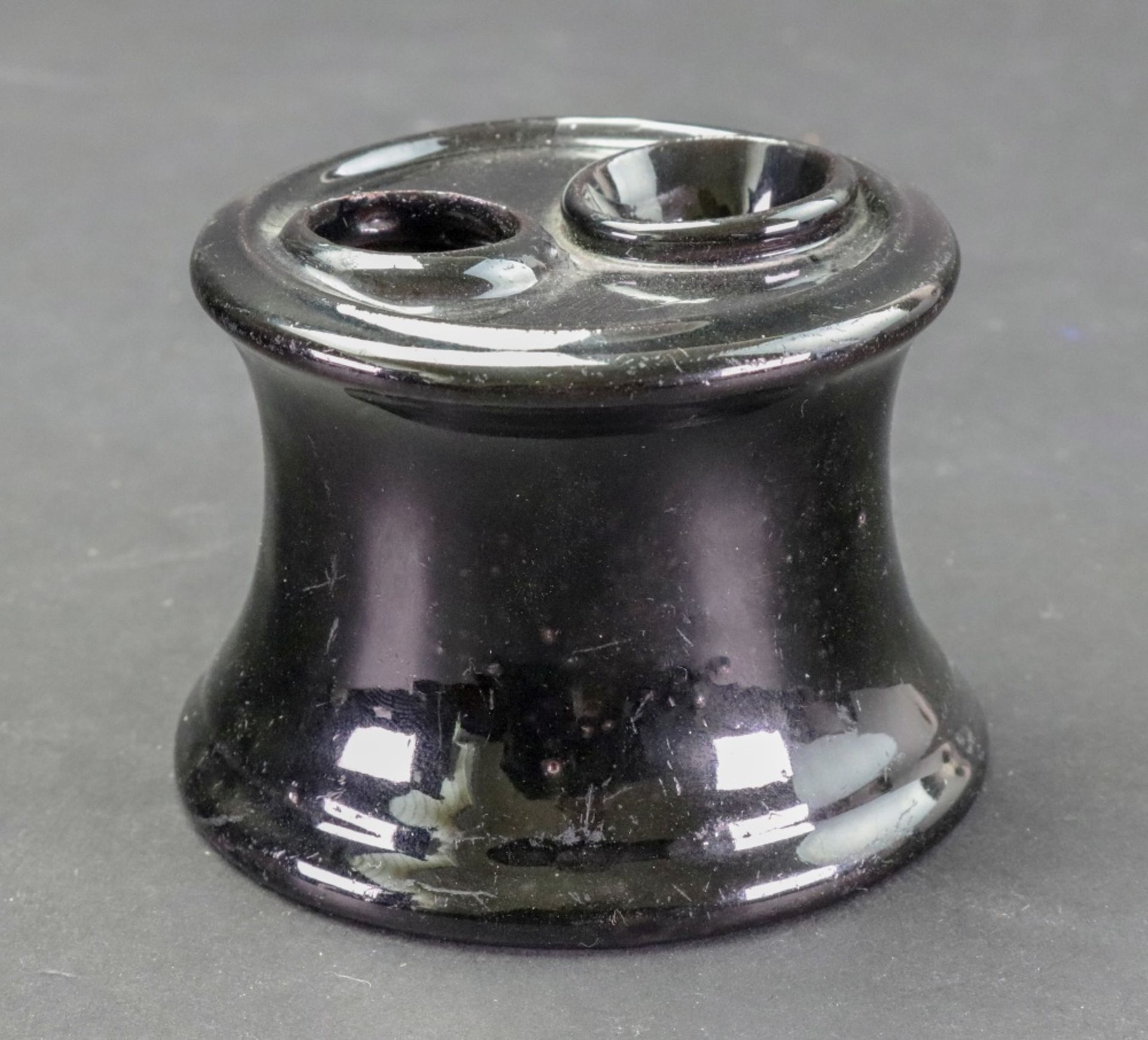 A Staffordshire 'Jackfield' style inkwell, circa 1760-70, of capstan form,