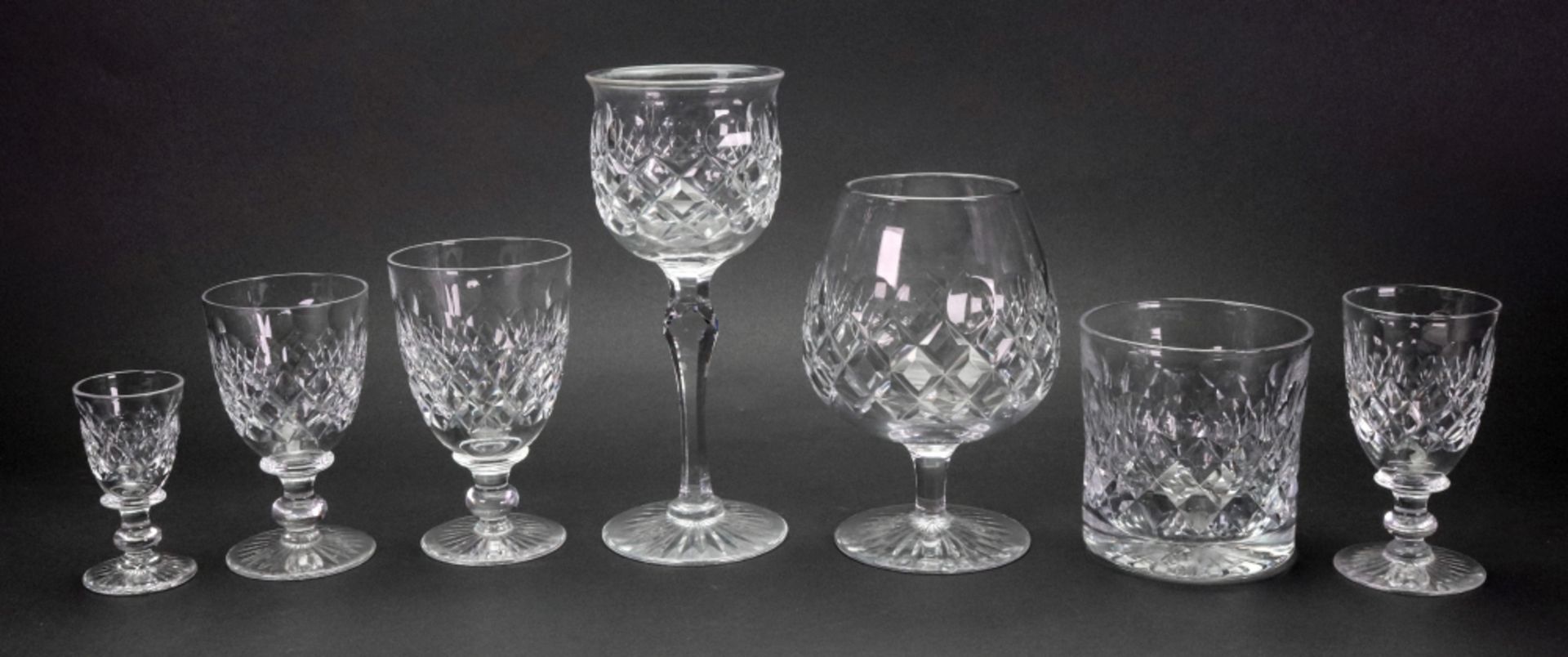 A suite of Tudor facet and diamond cut glassware, with star cut bases, 90 pieces,