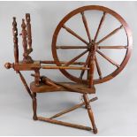 A turned oak, beech and elm spinning wheel, 19th century, of typical form, the wheel 24" diameter,