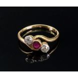 A 18ct gold, ruby and diamond three-stone cross-over ring, the central collet-set circular-cut ruby,