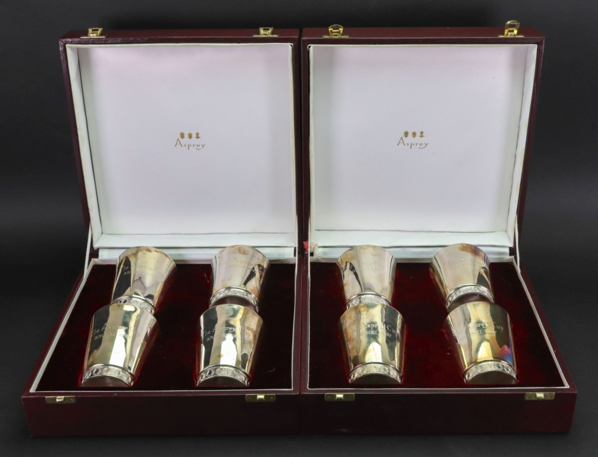 Asprey; a cased set of four electroplate beakers, each engraved 'The Asprey Cup,