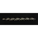 A silver fancy-link bracelet, designed as waved scroll links, to an oval shaped clasp, 0.86ozs.