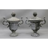 A pair of weathered lead terrace urns and covers, after the antique,
