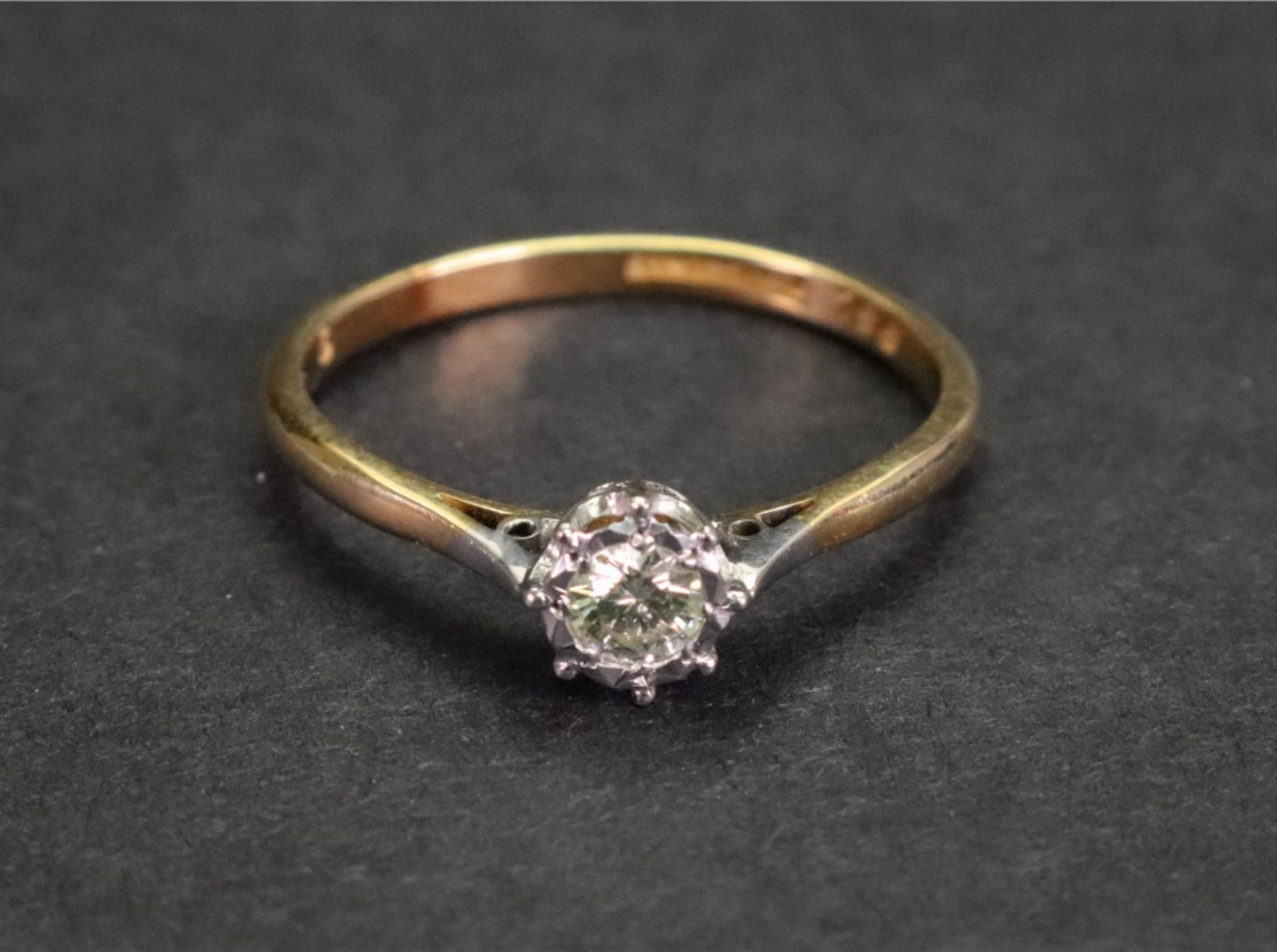 An 18ct gold and platinum, diamond-set single-stone ring, the diamond approximately 1/4ct,