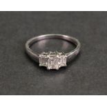 A platinum and diamond three-stone ring, the central Princess-cut diamond, claw set,