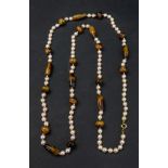 A single row necklace of uniform cultured pearls,