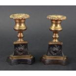 A pair of Empire gilt metal and bronze dwarf candlesticks,