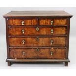A late 17th century oak and walnut chest of drawers, of panelled construction,