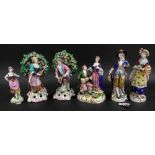 A pair of Sampson porcelain figures of musicians, in Chelsea style, each standing in bocage,