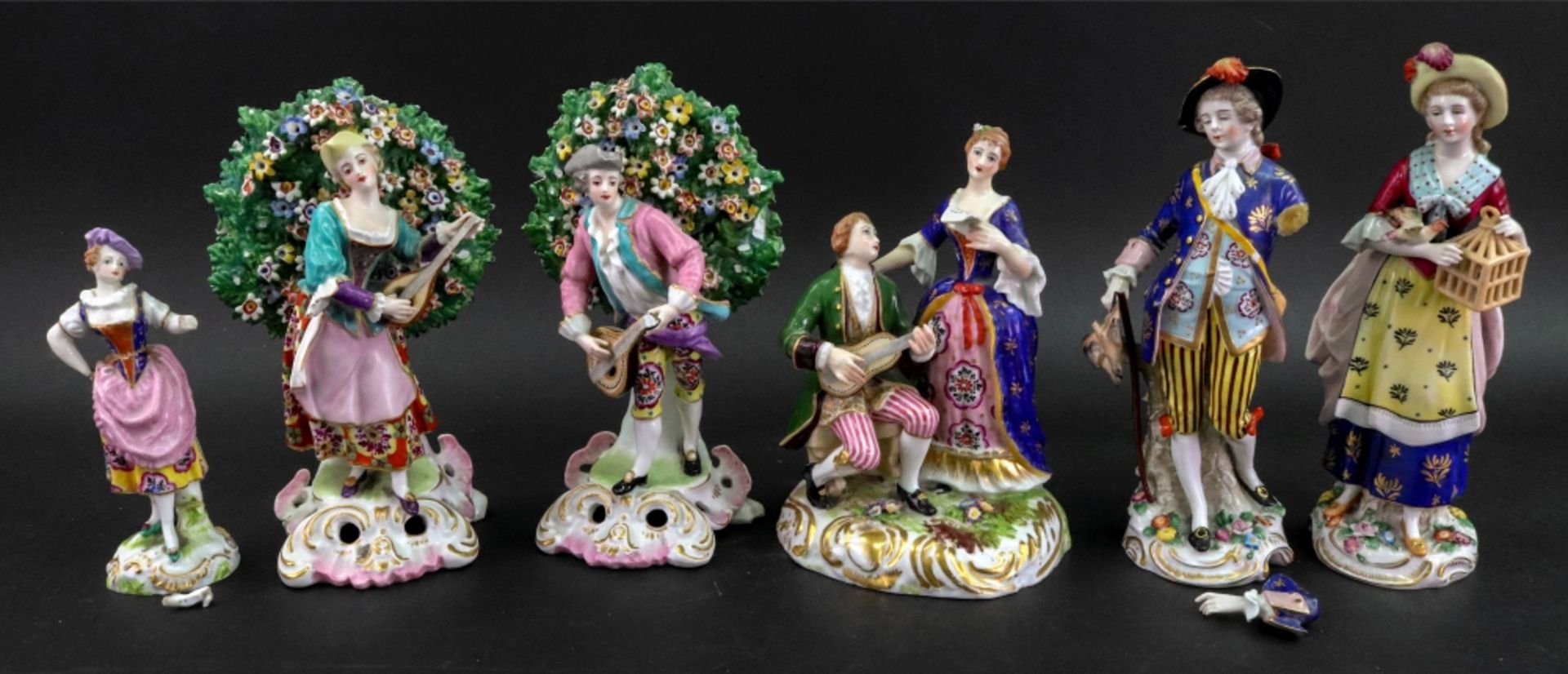 A pair of Sampson porcelain figures of musicians, in Chelsea style, each standing in bocage,