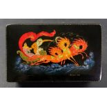 A Russian rectangular black lacquer papier mache box, the hinged cover painted with a troika scene,