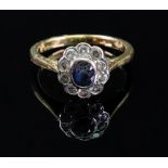 A sapphire and diamond cluster ring, the collet-set oval-cut sapphire,