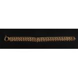 A 9ct gold stylised figure of eight-link bracelet, of textured and smooth design,