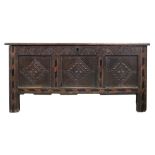 A late 17th century oak coffer, of panelled construction, with hinged top,