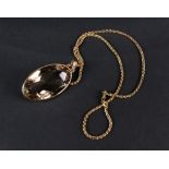 A 9ct gold mounted smoky quartz pendant, on a stylised yellow precious metal Spiga chain necklace,