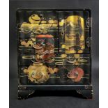 A Japanese black lacquered table top cabinet, Meiji, gilt and painted with landscape,