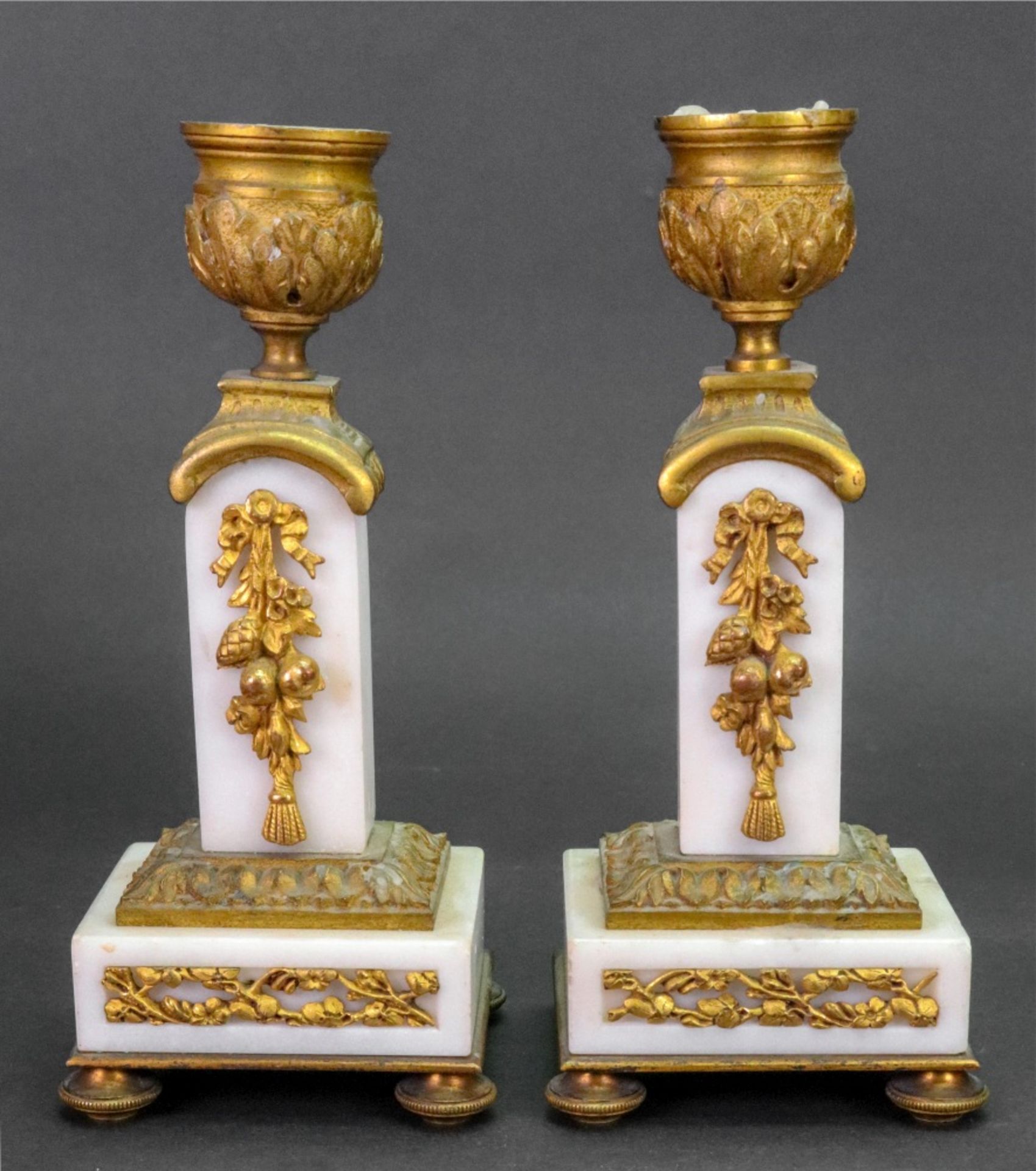 A pair of Louis XVI style gilt metal mounted white marble candlesticks, circa 1880,